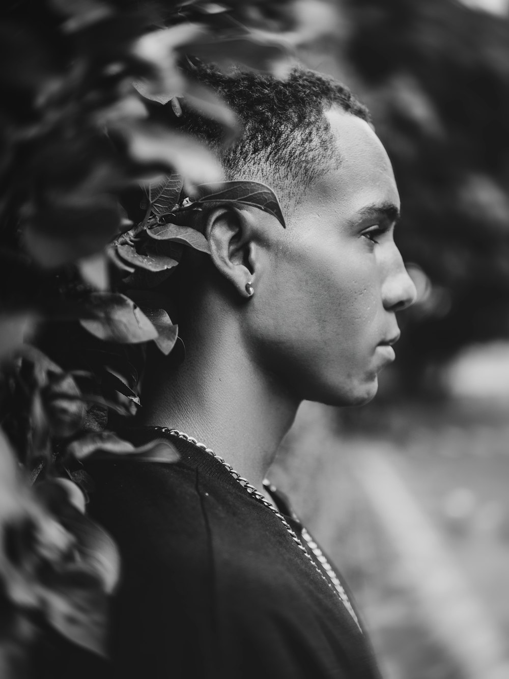 a black and white photo of a man with a mohawk