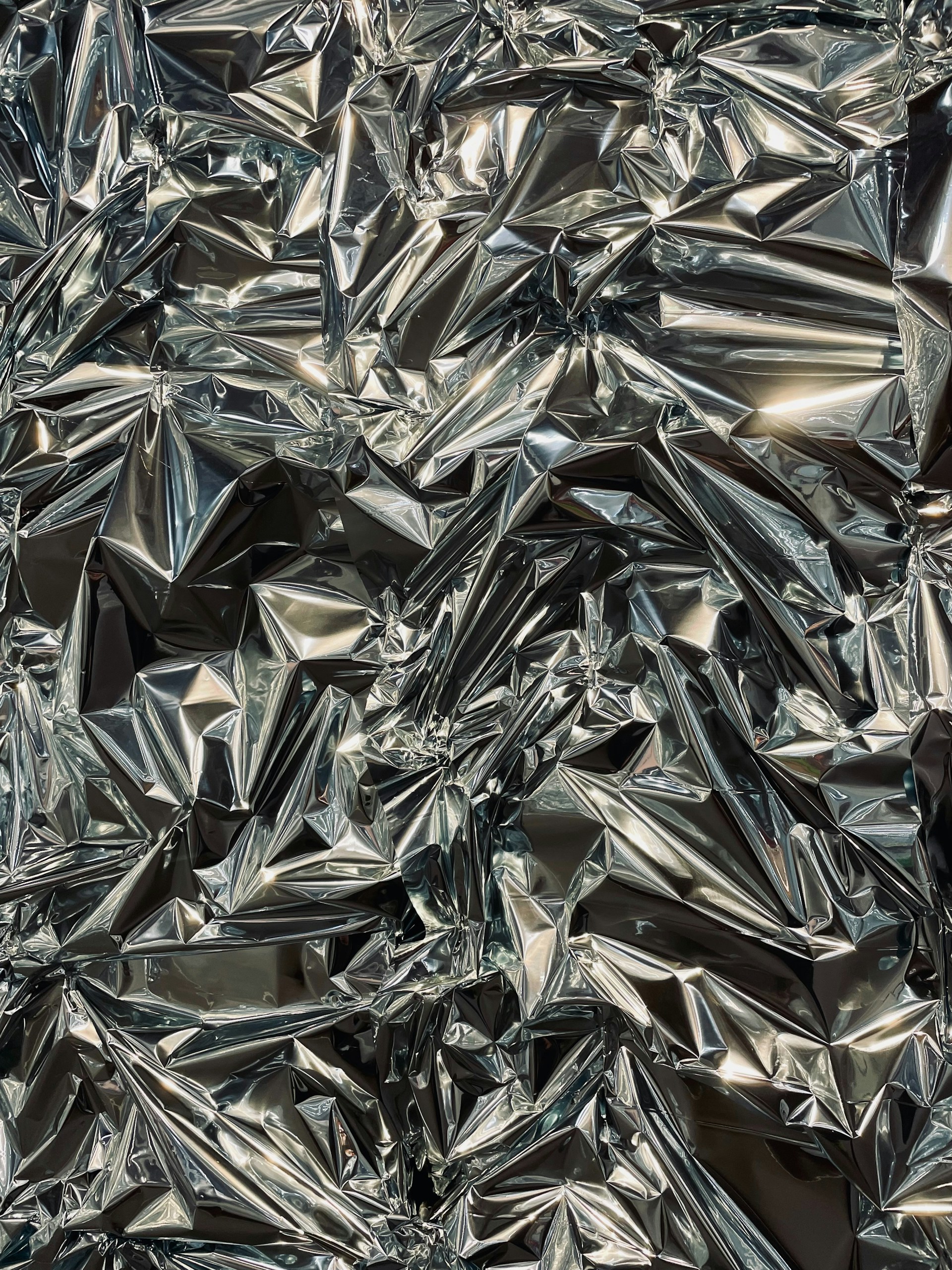 a large pile of shiny silver foil