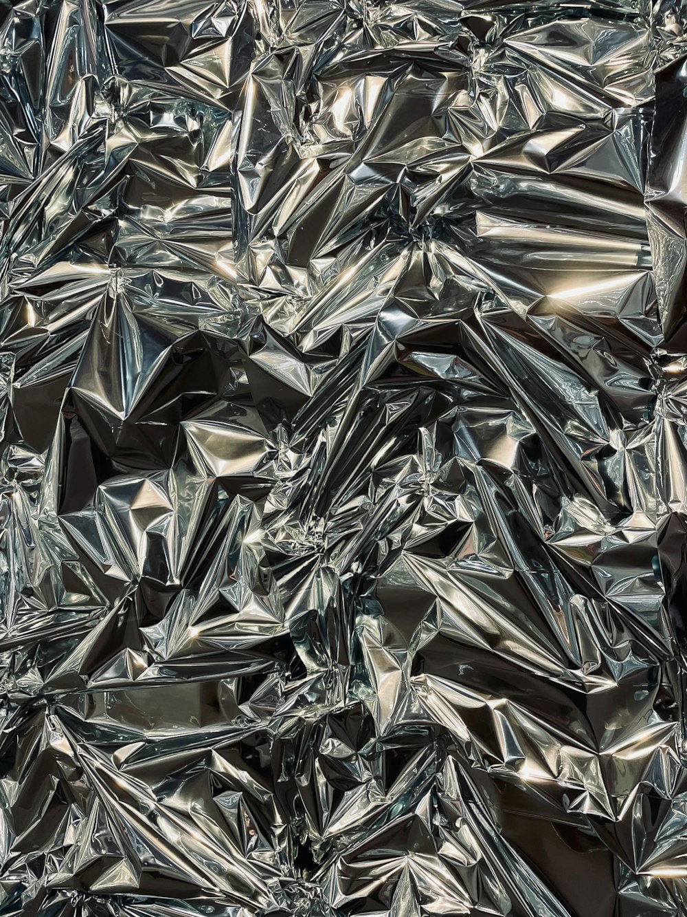 a large pile of shiny silver foil