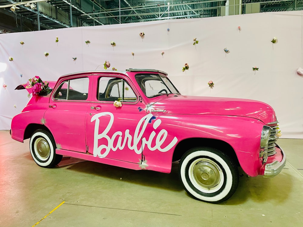 a pink car with a bride's name painted on it