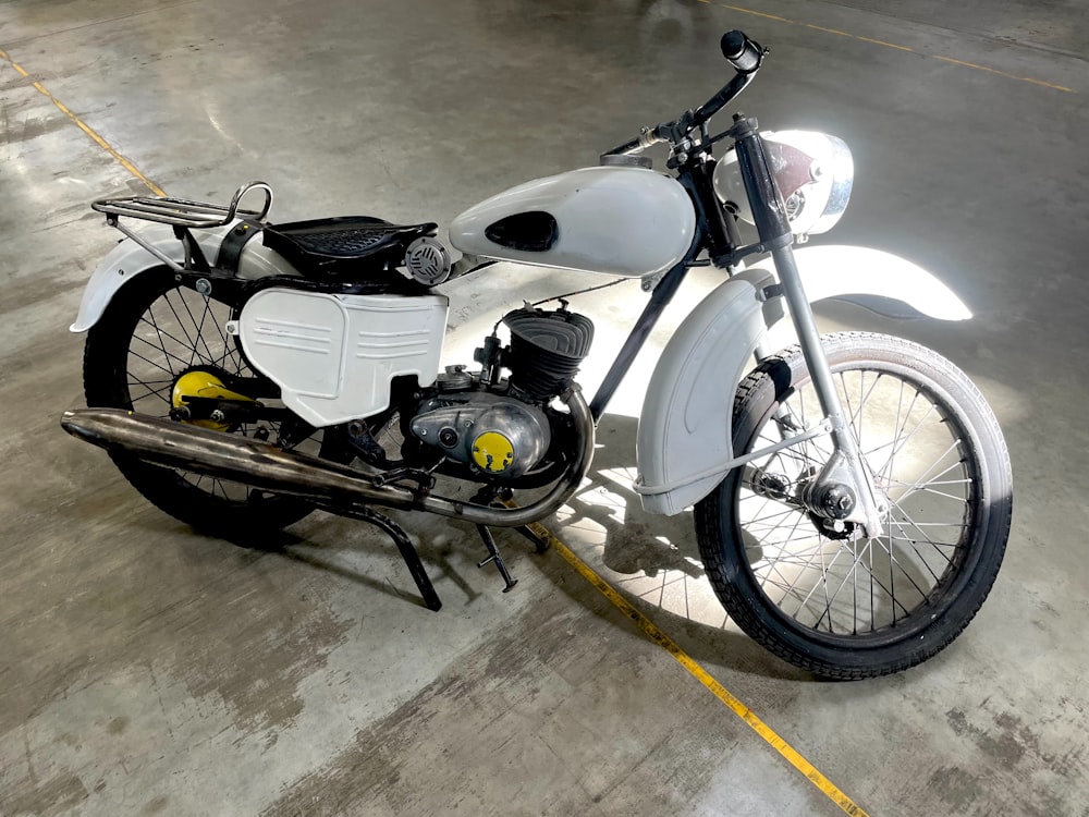 a white and black motorcycle parked in a parking lot