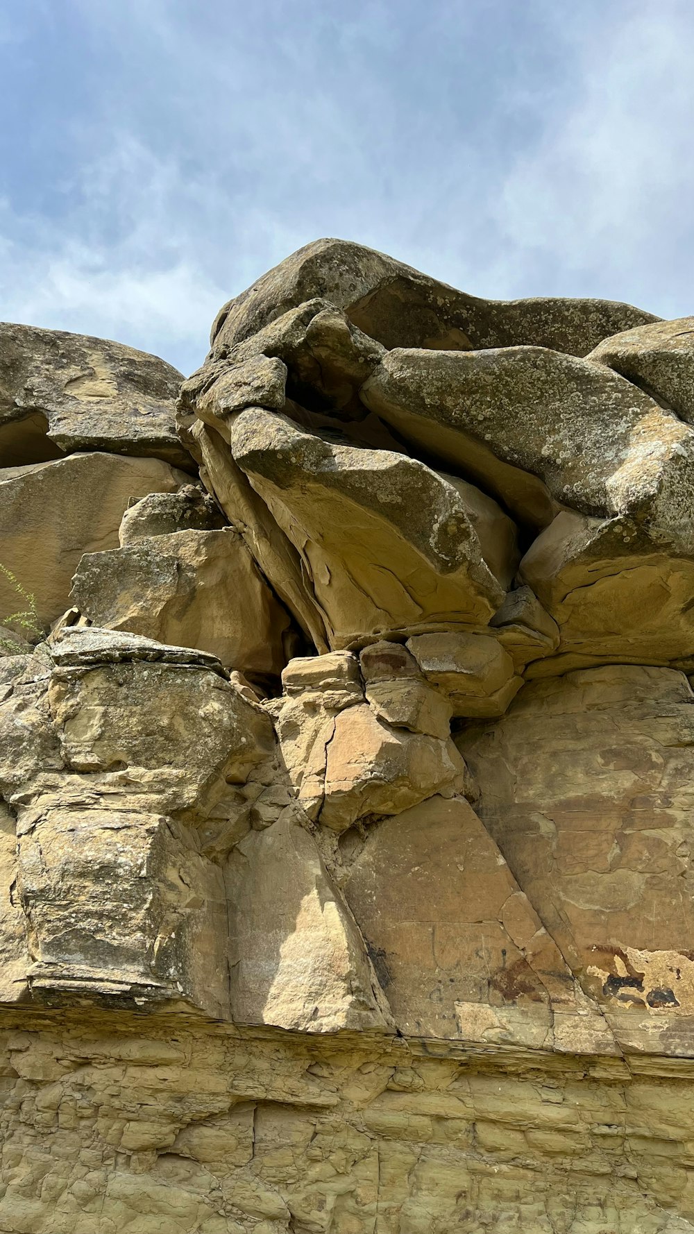 a large rock formation with a sky in the background