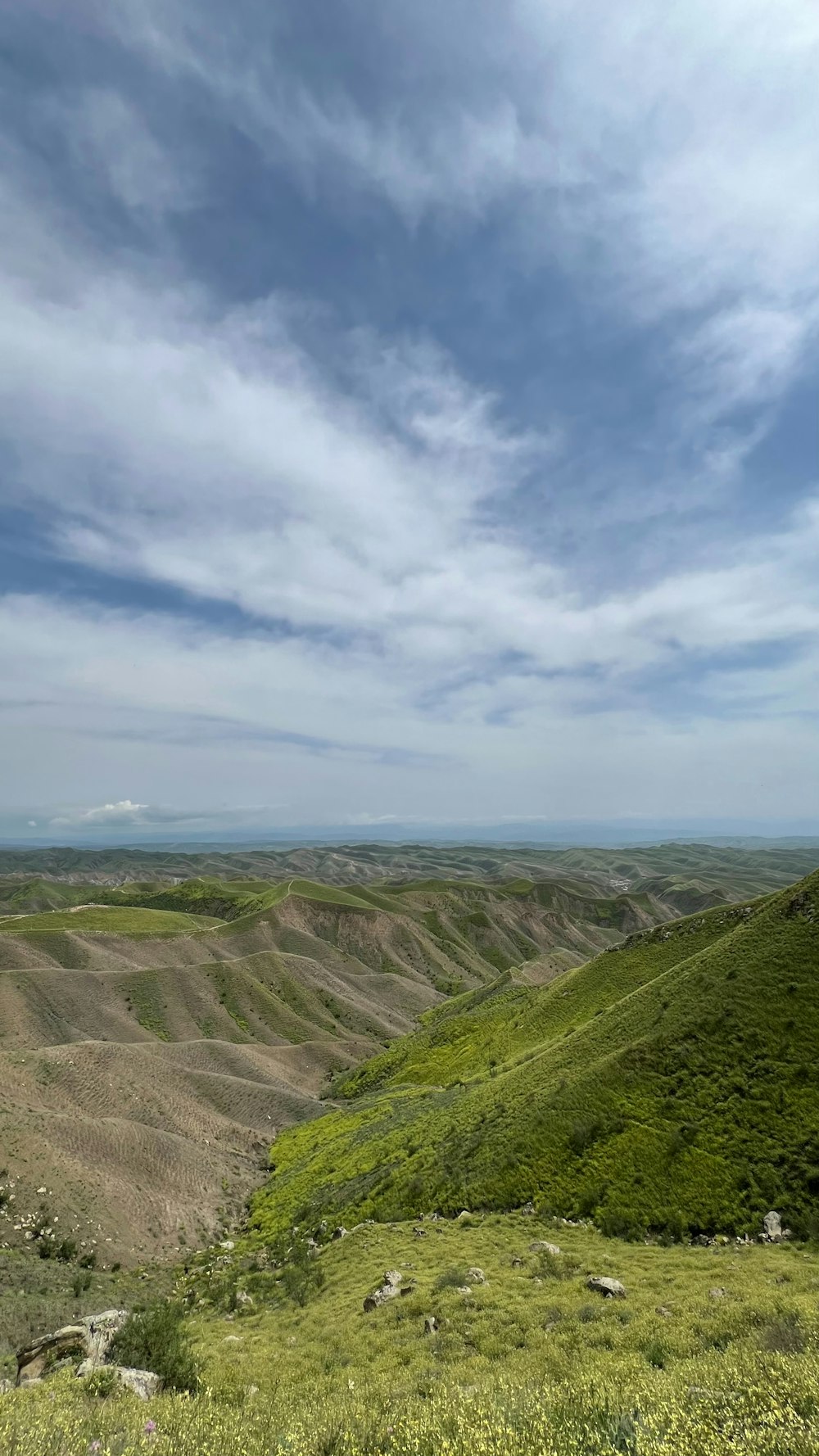 a scenic view of a valley and mountains