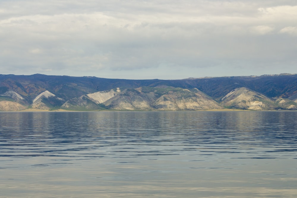 a large body of water with mountains in the background