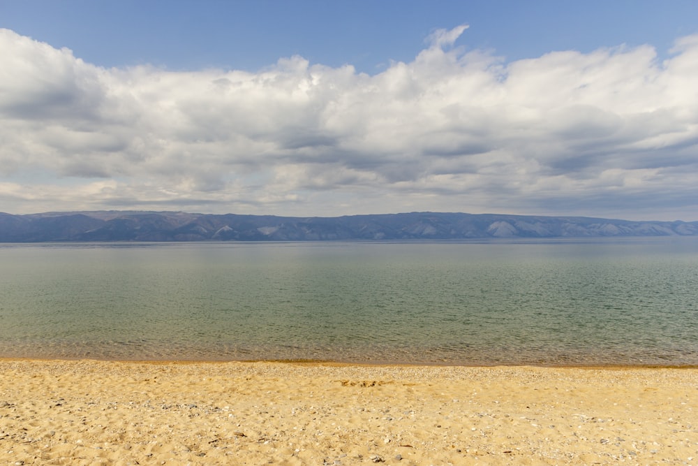 a view of a body of water with mountains in the background