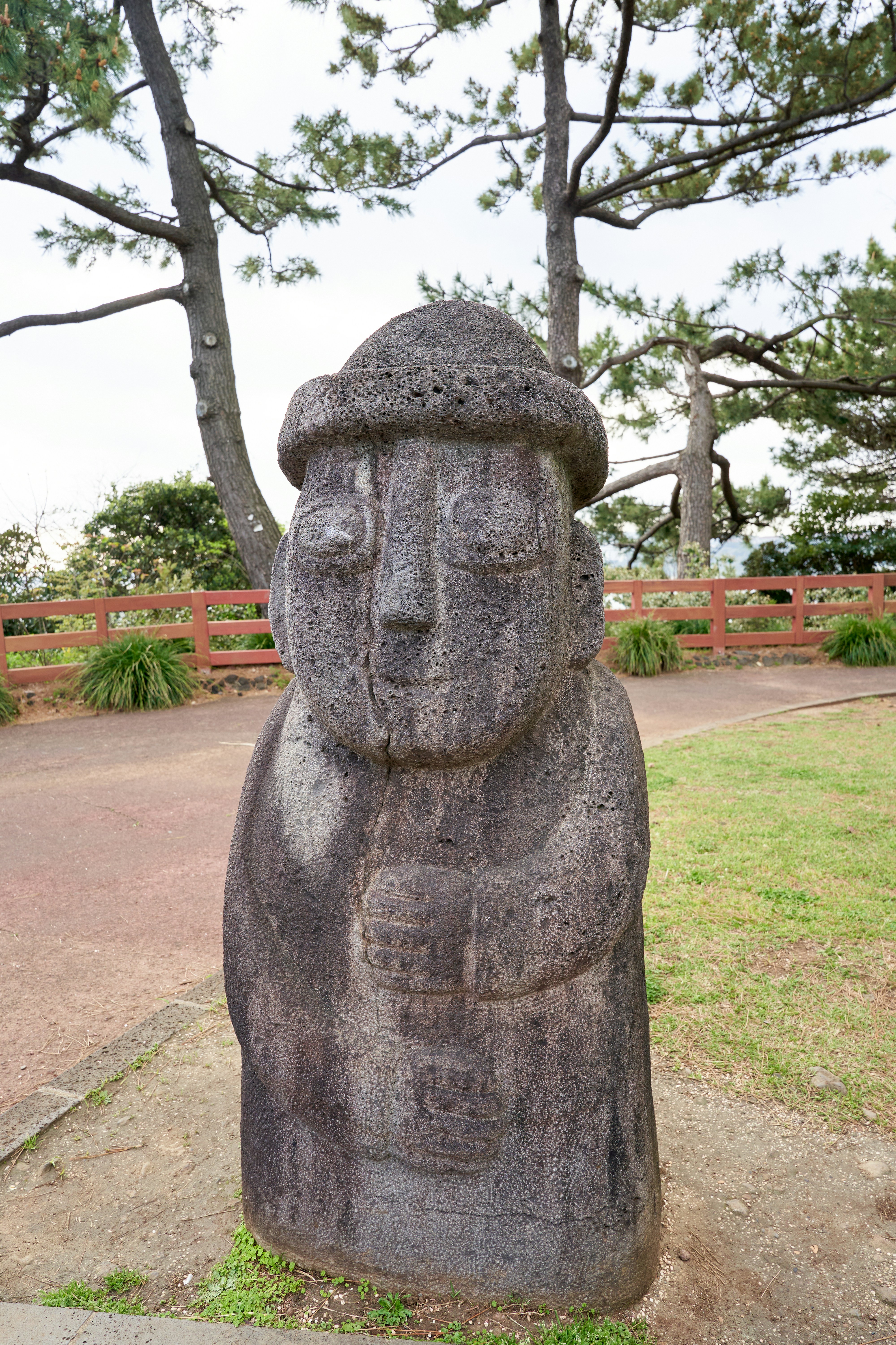 a stone statue of a person with a hat on