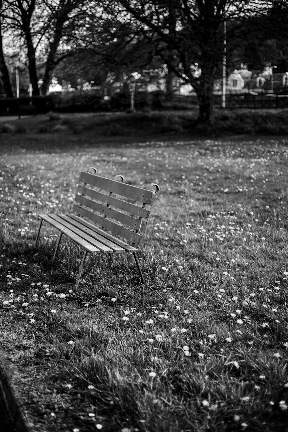 a black and white photo of a park bench
