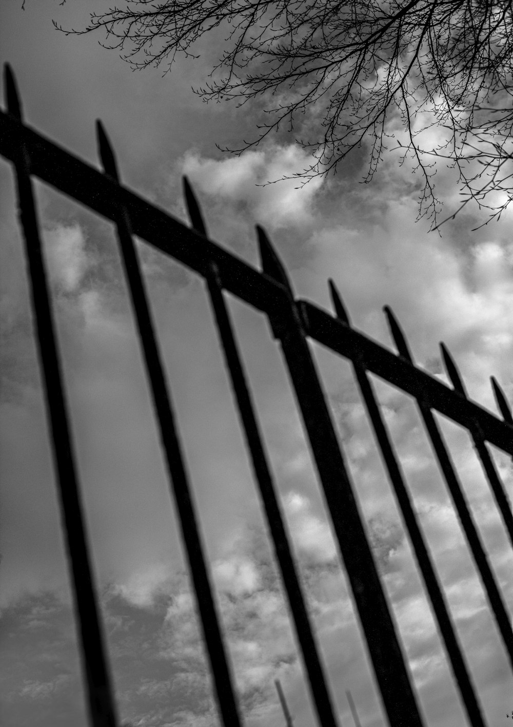 a black and white photo of a fence