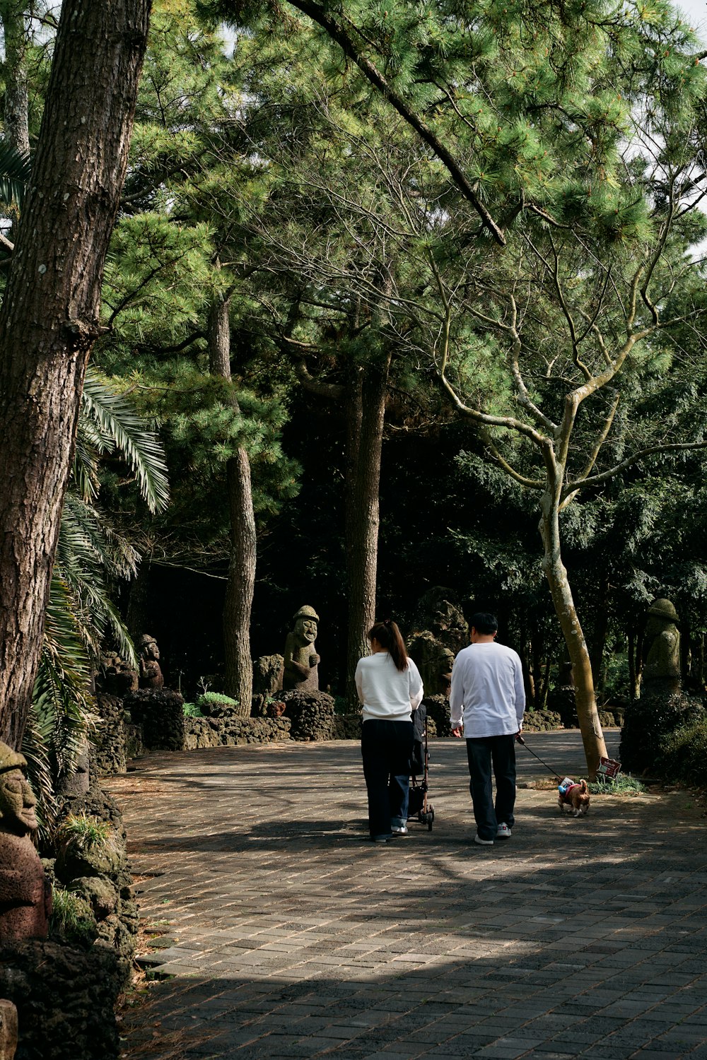 a man and a woman walking down a path