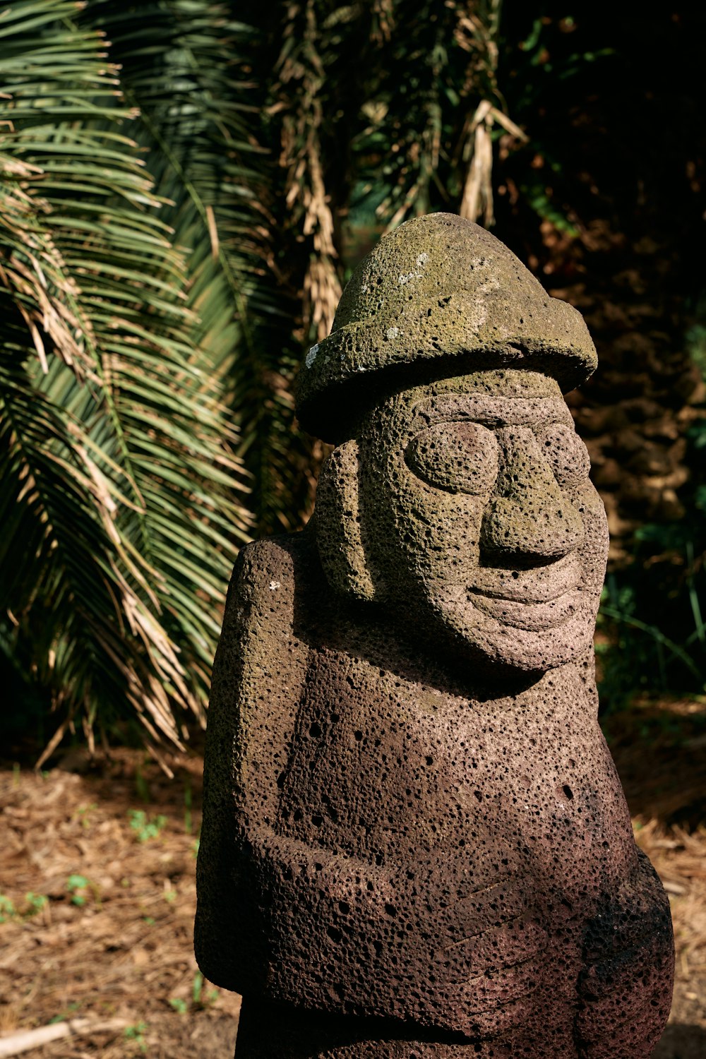 a stone statue of a man with a hat on