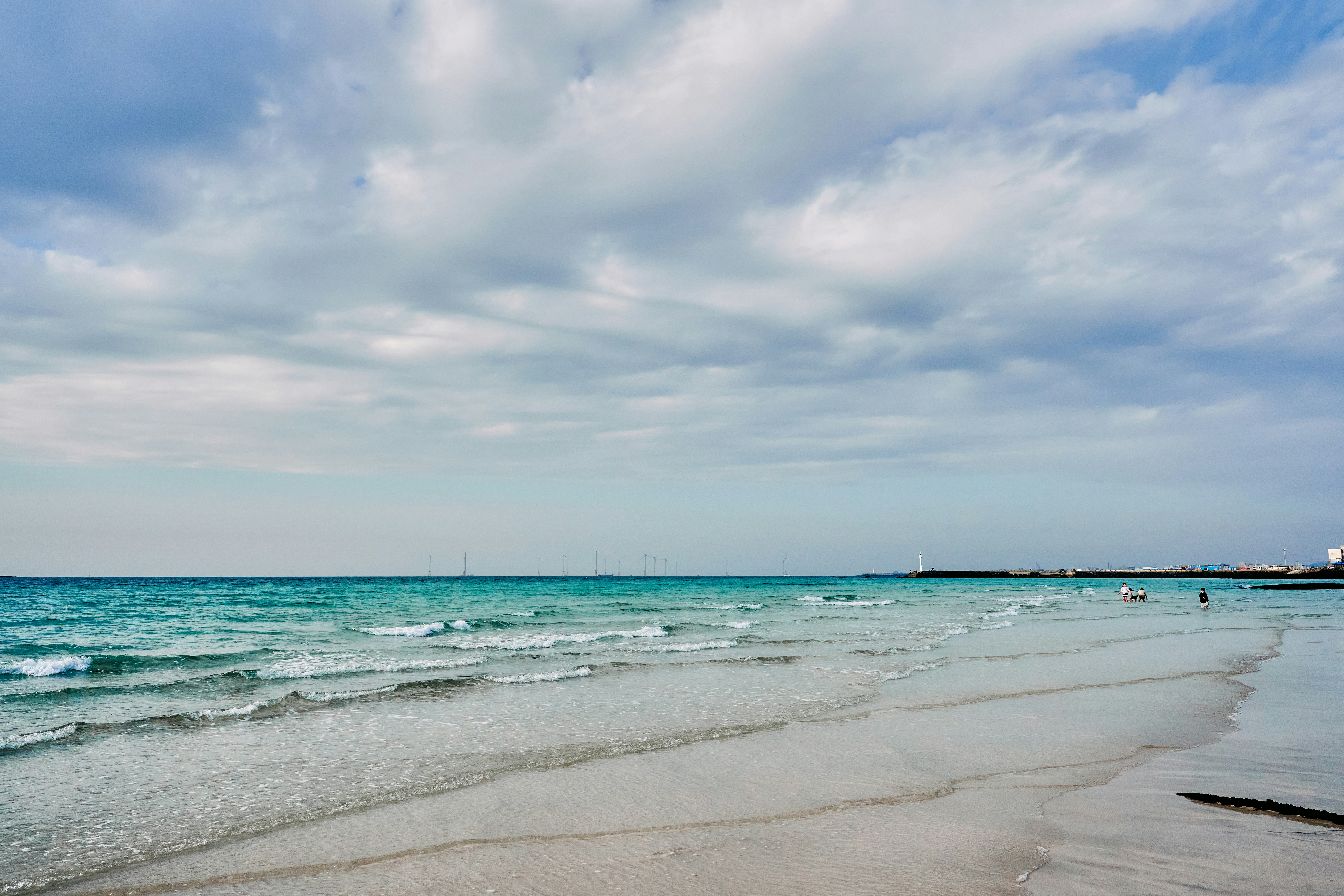 A sandy beach with waves coming in to shore photo – Free Sea Image on ...
