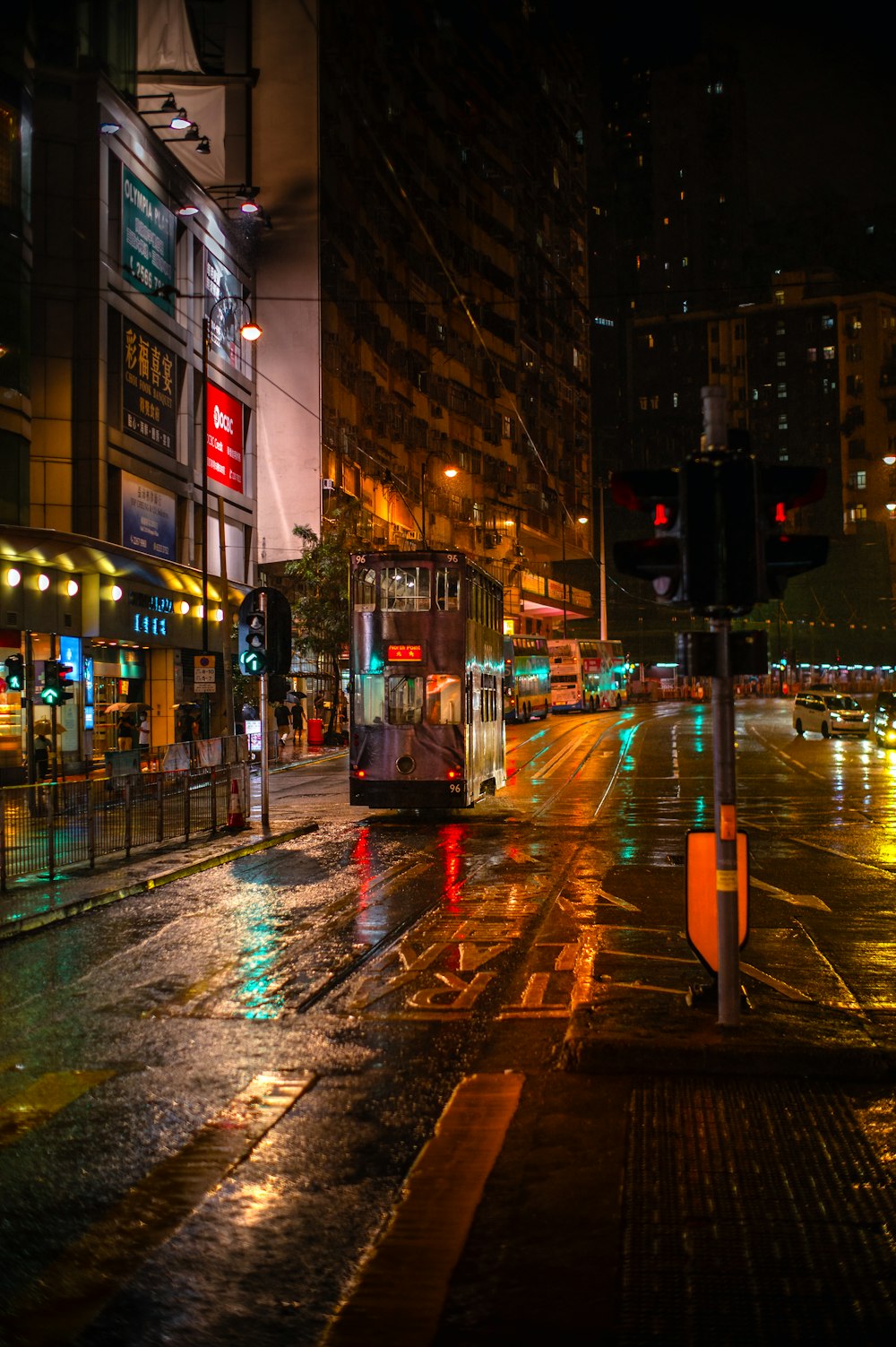 a city street at night with traffic lights