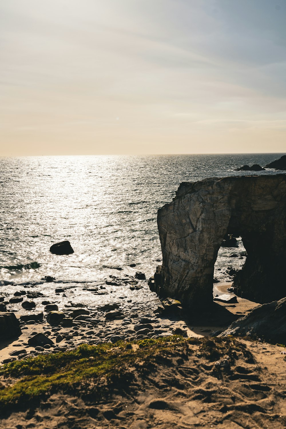 a large rock outcropping in the middle of the ocean