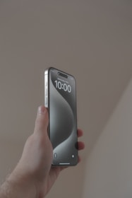 a person holding a cell phone in their hand
