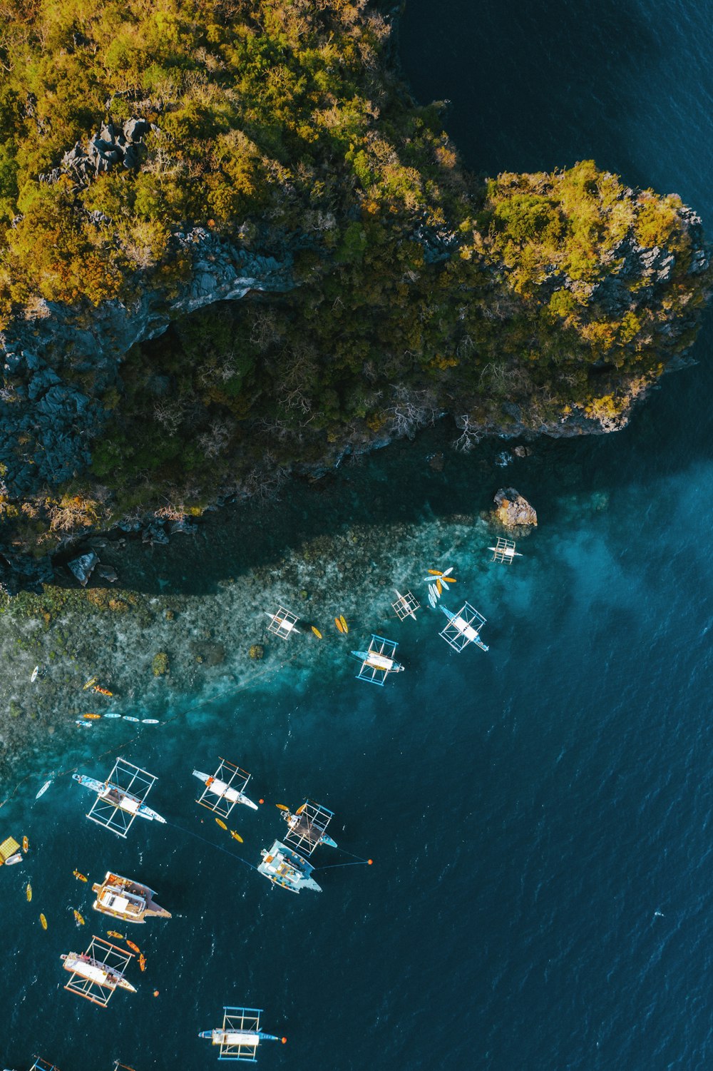 a group of boats floating on top of a body of water