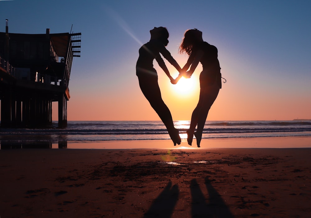 a couple of people that are standing in the sand