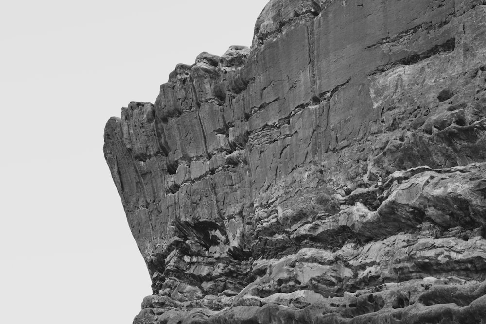 a black and white photo of a rocky cliff