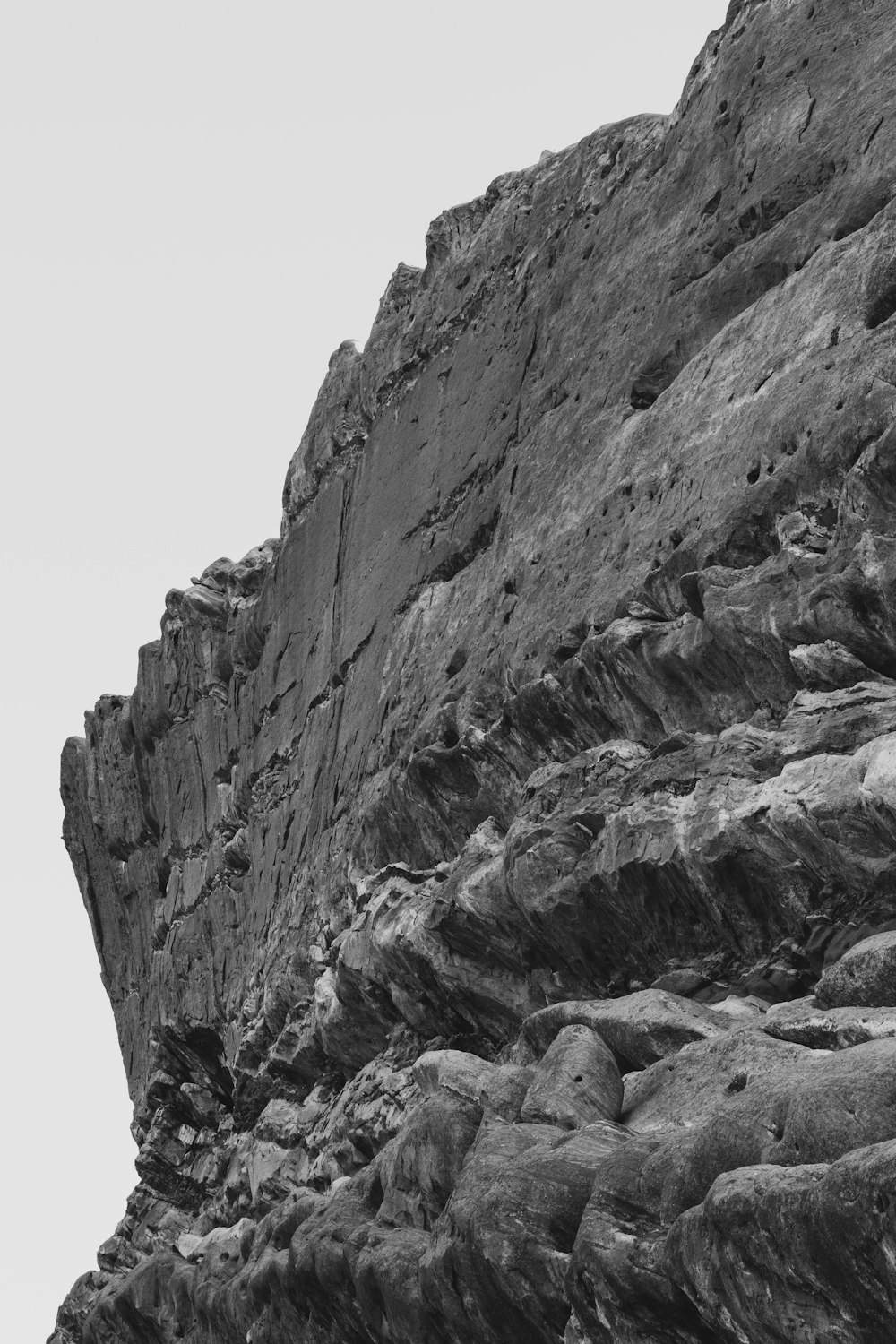 a black and white photo of a rocky cliff