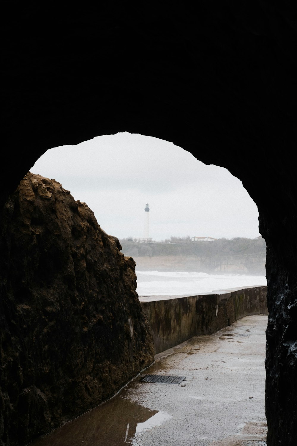 a view of the ocean through a tunnel