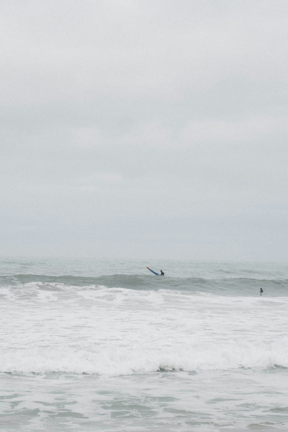 a person riding a surfboard on a wave in the ocean