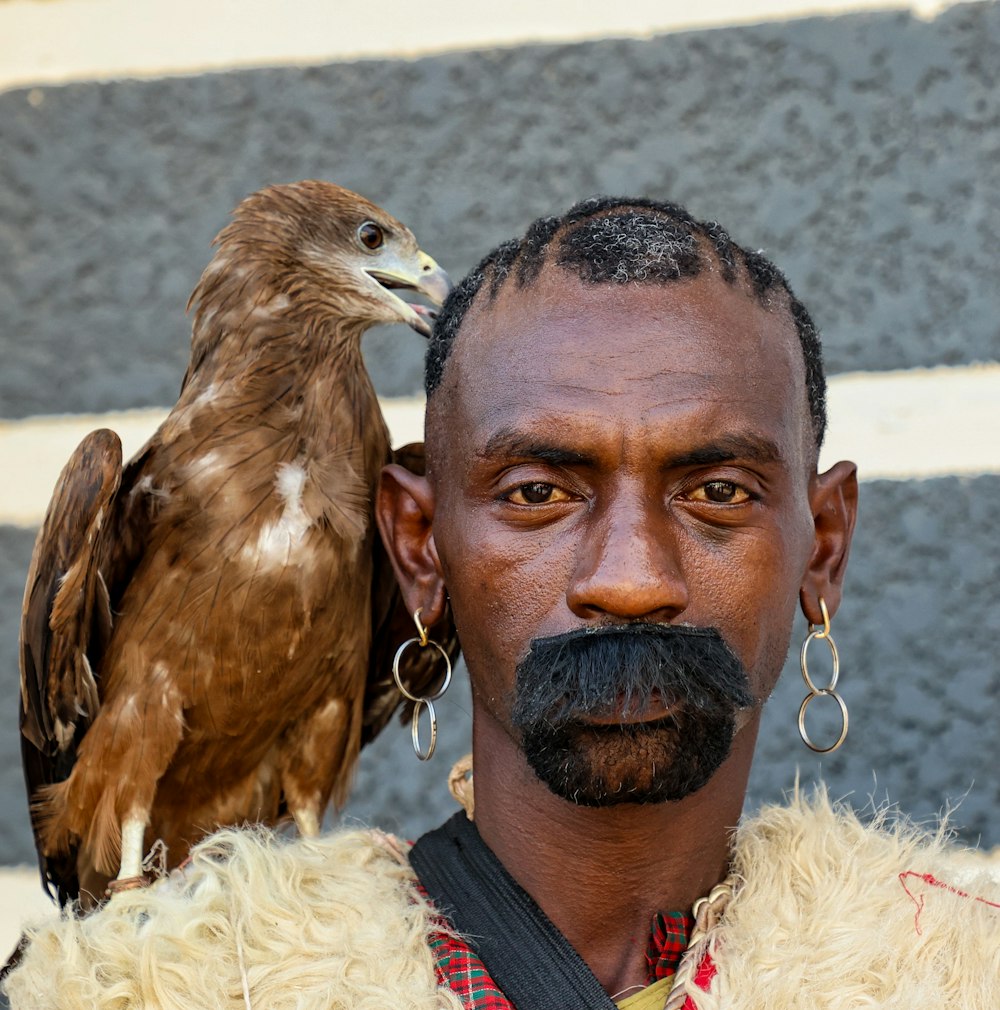 a man with a bird on his shoulder