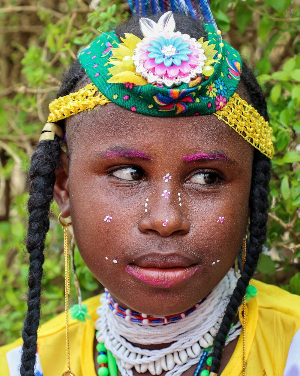 a young girl with a painted face and braids