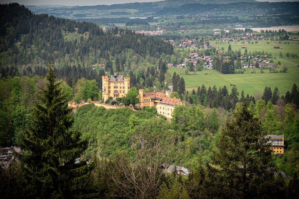 a large building on top of a lush green hillside
