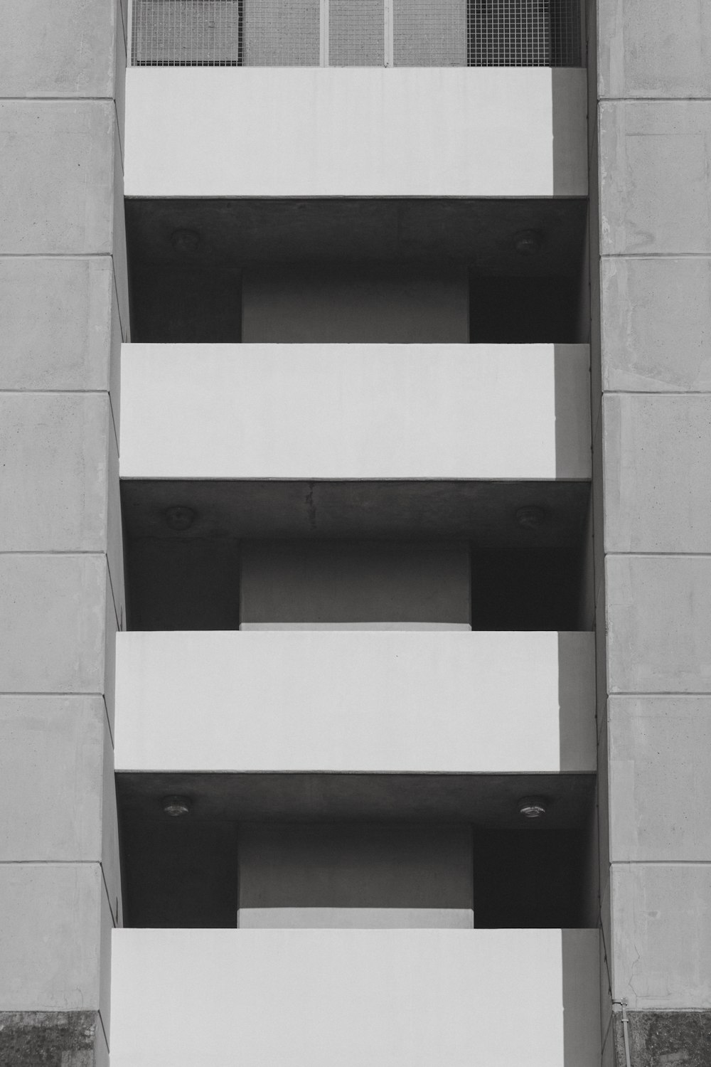 a black and white photo of a building with balconies