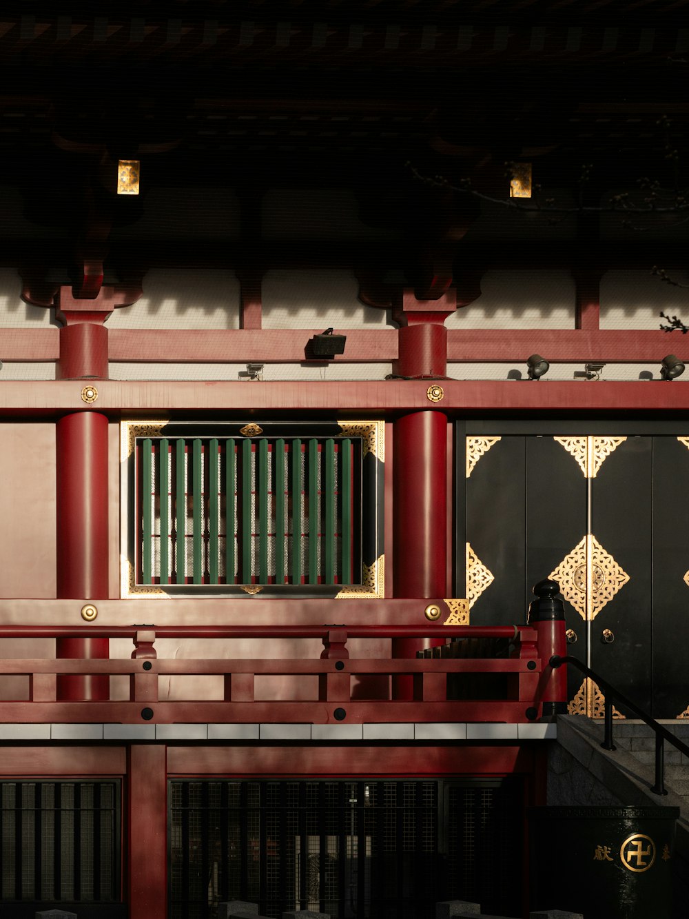 a red building with a green door and a window