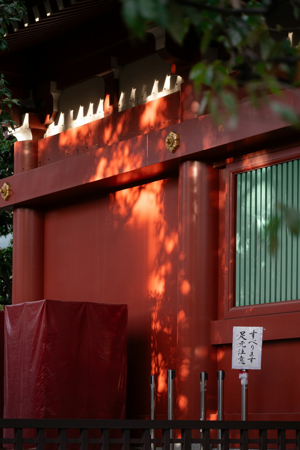 a red building with a red fence around it