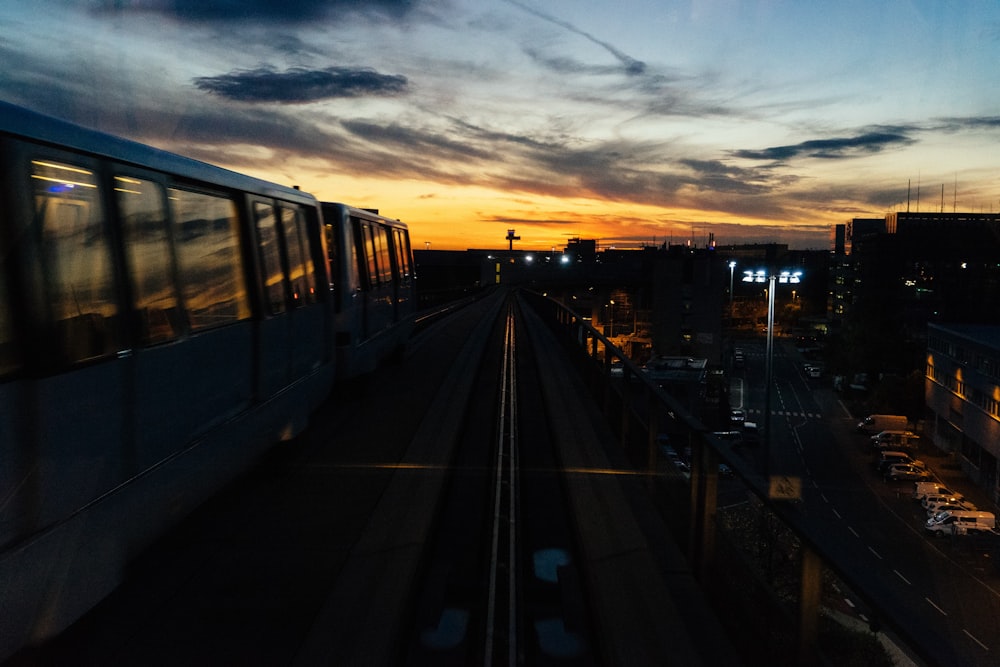 a train traveling down train tracks next to tall buildings