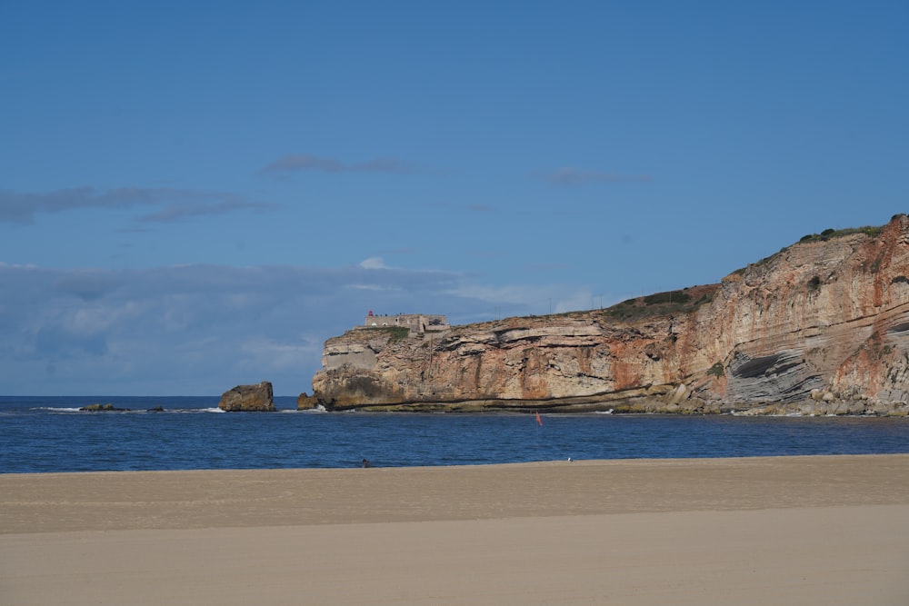 a large rock outcropping next to a body of water