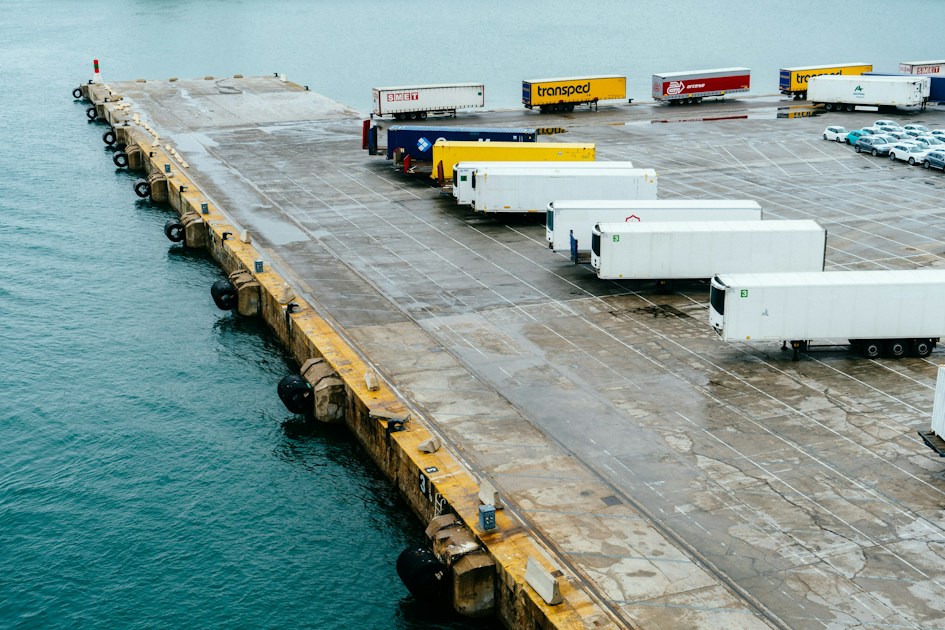 A dock with a bunch of trucks parked on it