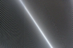 a black and white photo of a plane flying in the sky