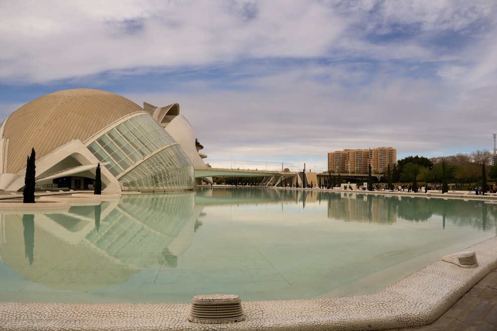 a large building sitting next to a pool of water