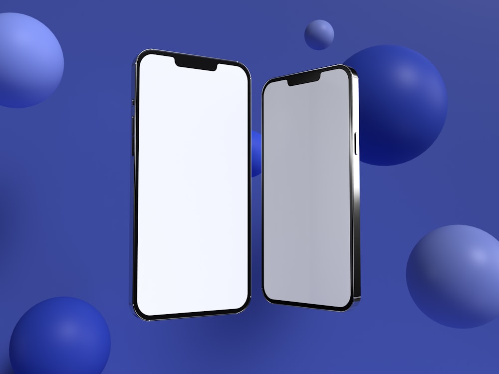 two cell phones are next to each other on a blue background