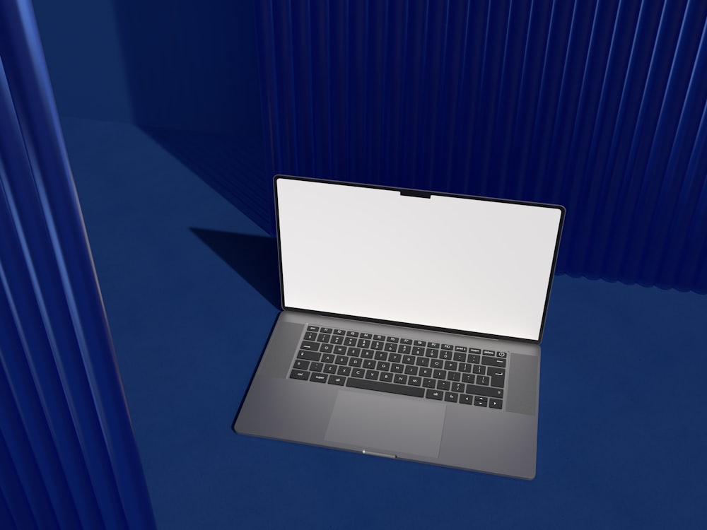 a laptop computer sitting on top of a blue table