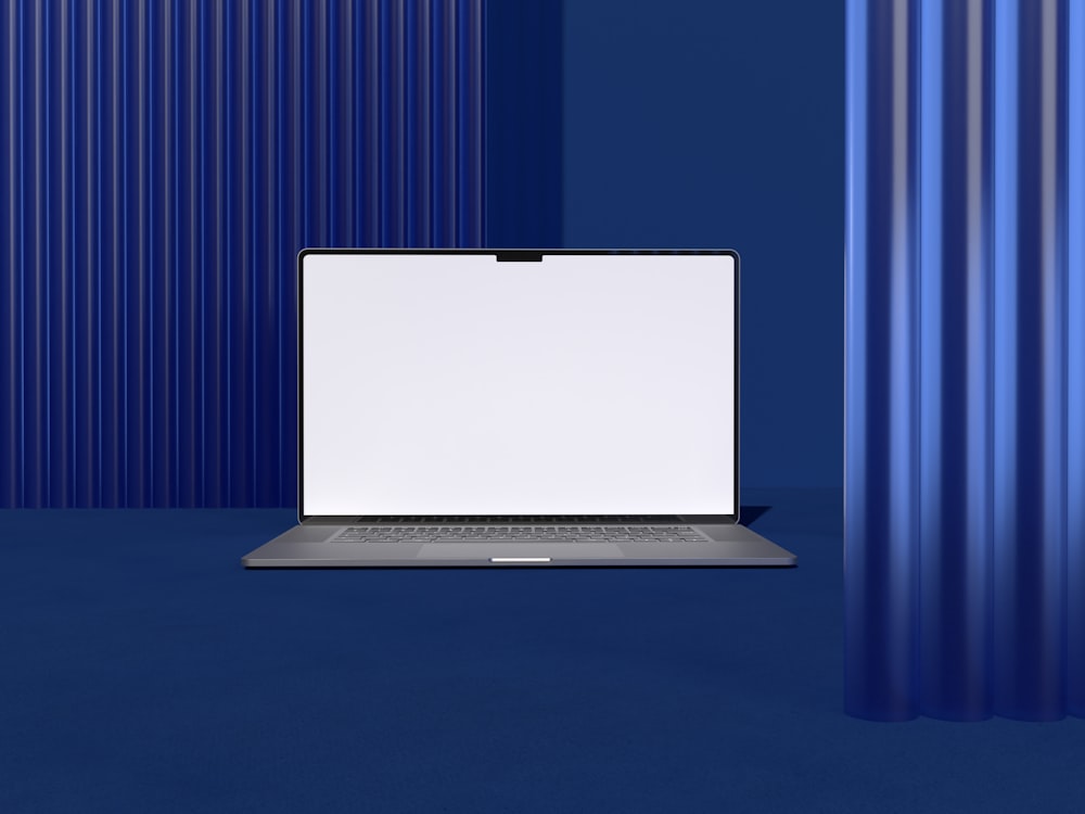 a laptop computer sitting on top of a blue floor