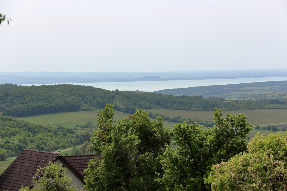 a scenic view of a valley and a body of water