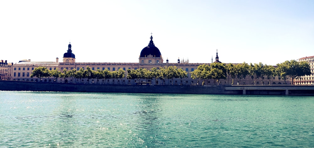 a large building sitting on the side of a river