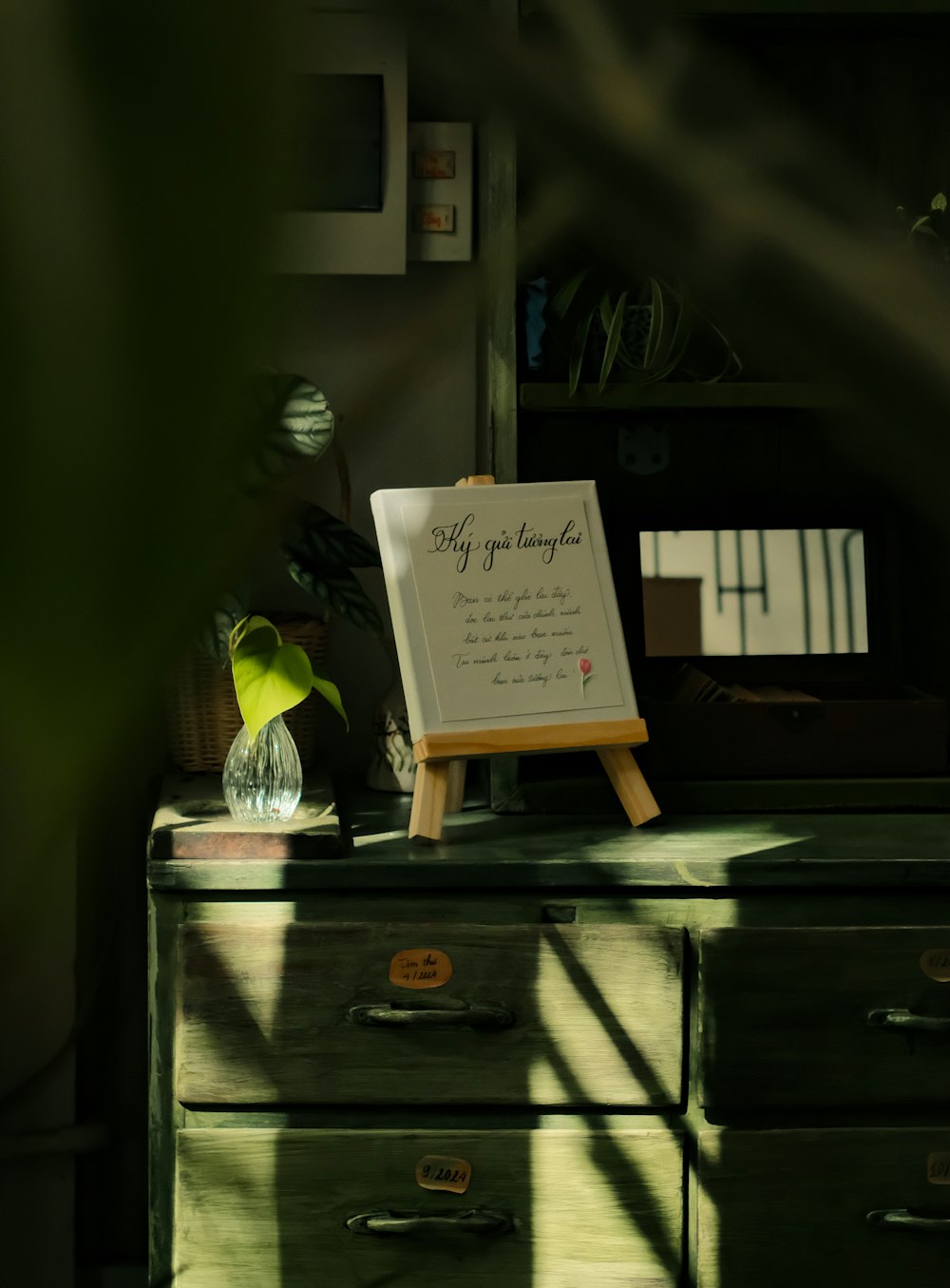 an easel with a poem on it sitting on a dresser