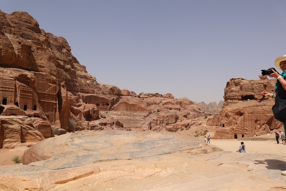 a woman taking a picture of people in the desert