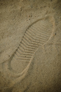 a picture of a shoe imprint in the sand
