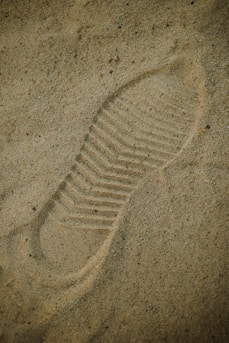 a picture of a shoe imprint in the sand