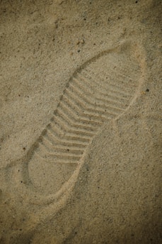a picture of a shoe imprint in the sand