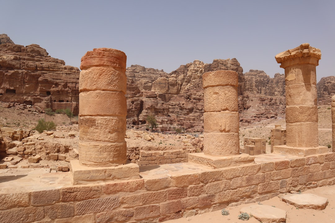 a group of stone pillars sitting in the middle of a desert,
