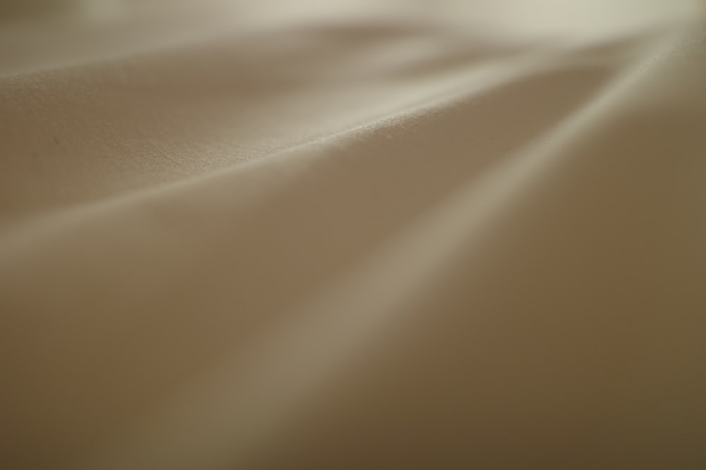 a blurry photo of a bed with white sheets