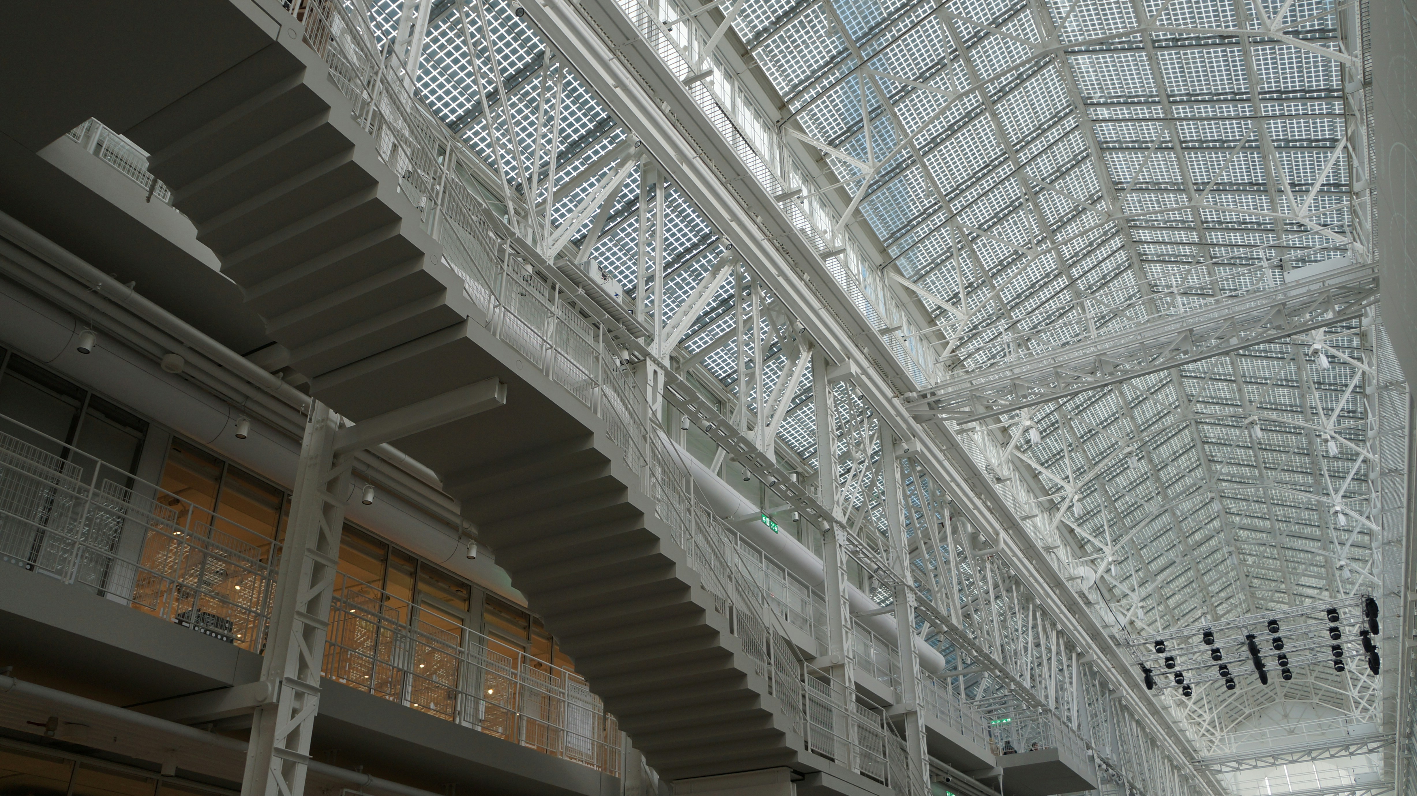 the ceiling of a large building with a lot of windows