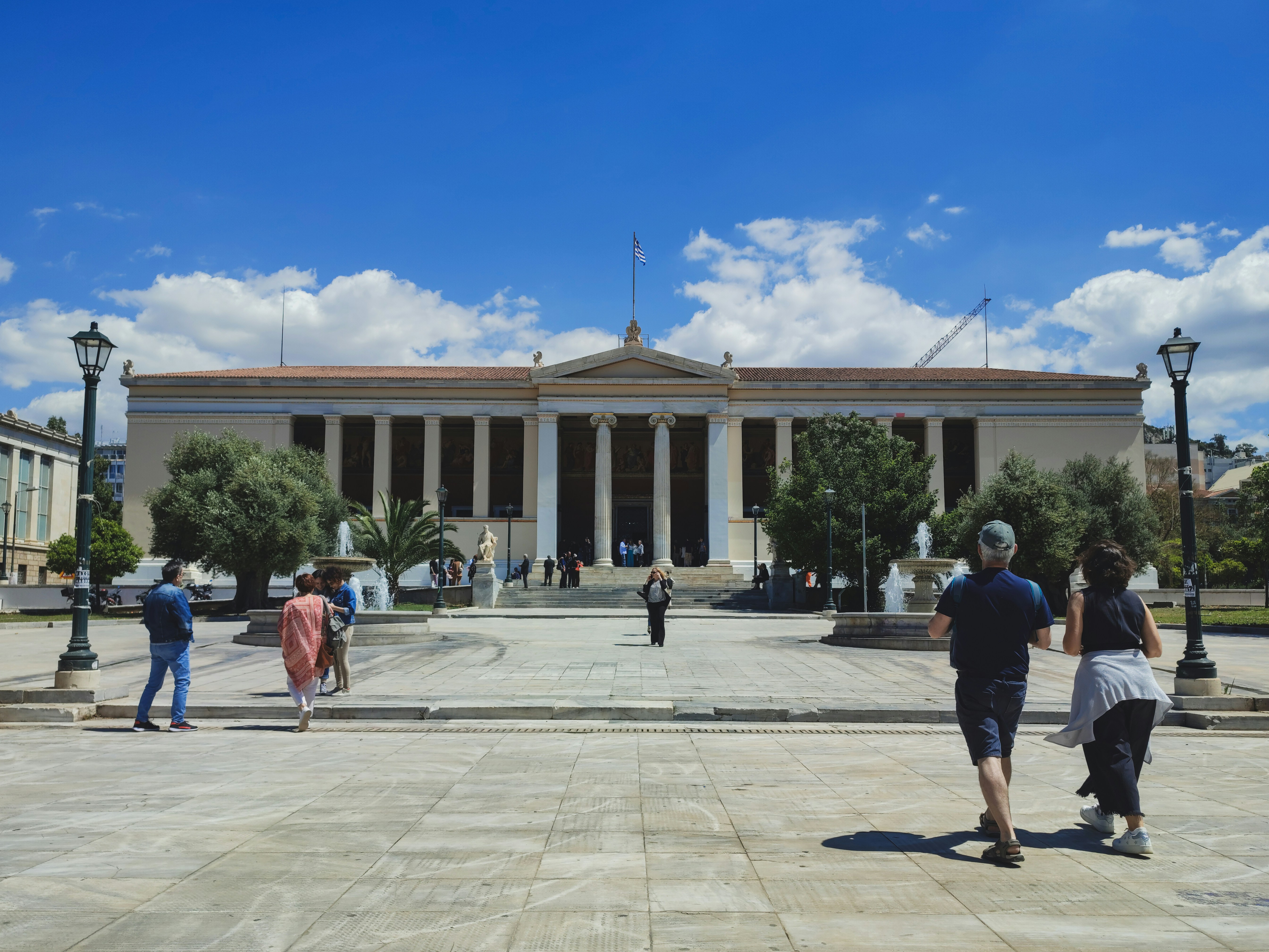 a group of people walking in front of a building