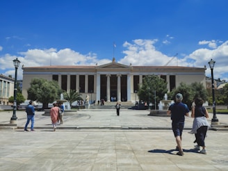 a group of people walking in front of a building